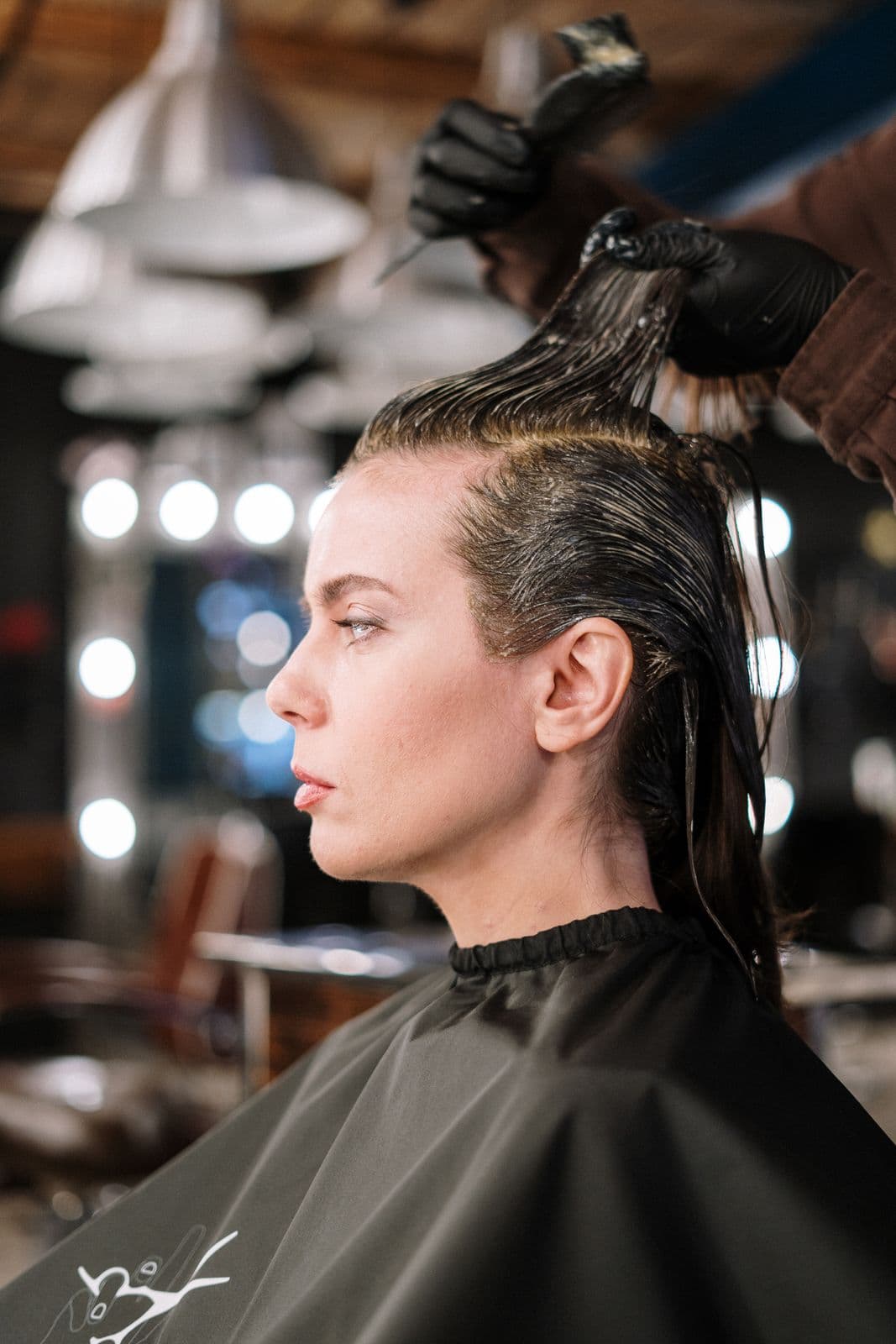 Colourist applying hair colour in the salon
